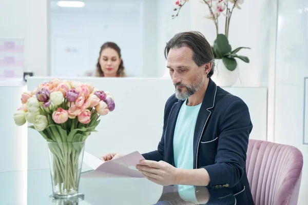 Kind attentive male person sitting in the lobby — стоковое фото