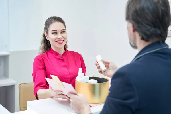 Positive delighted female looking at adult man — стоковое фото