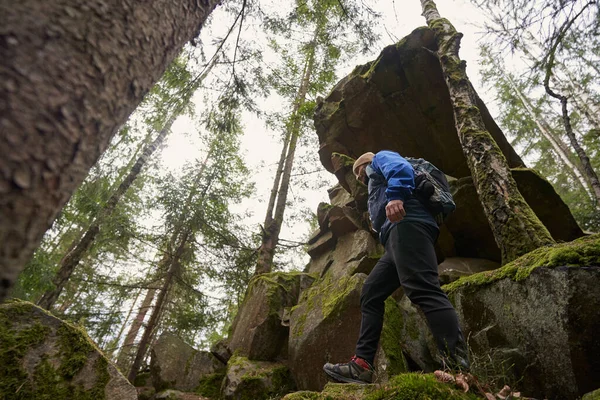 Low angle shot of hiker stepping on rocks in forest — 스톡 사진