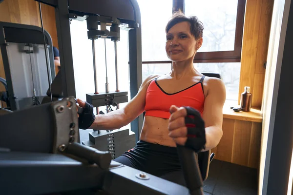 Muskulös idrottskvinna som tränar i fitness club — Stockfoto