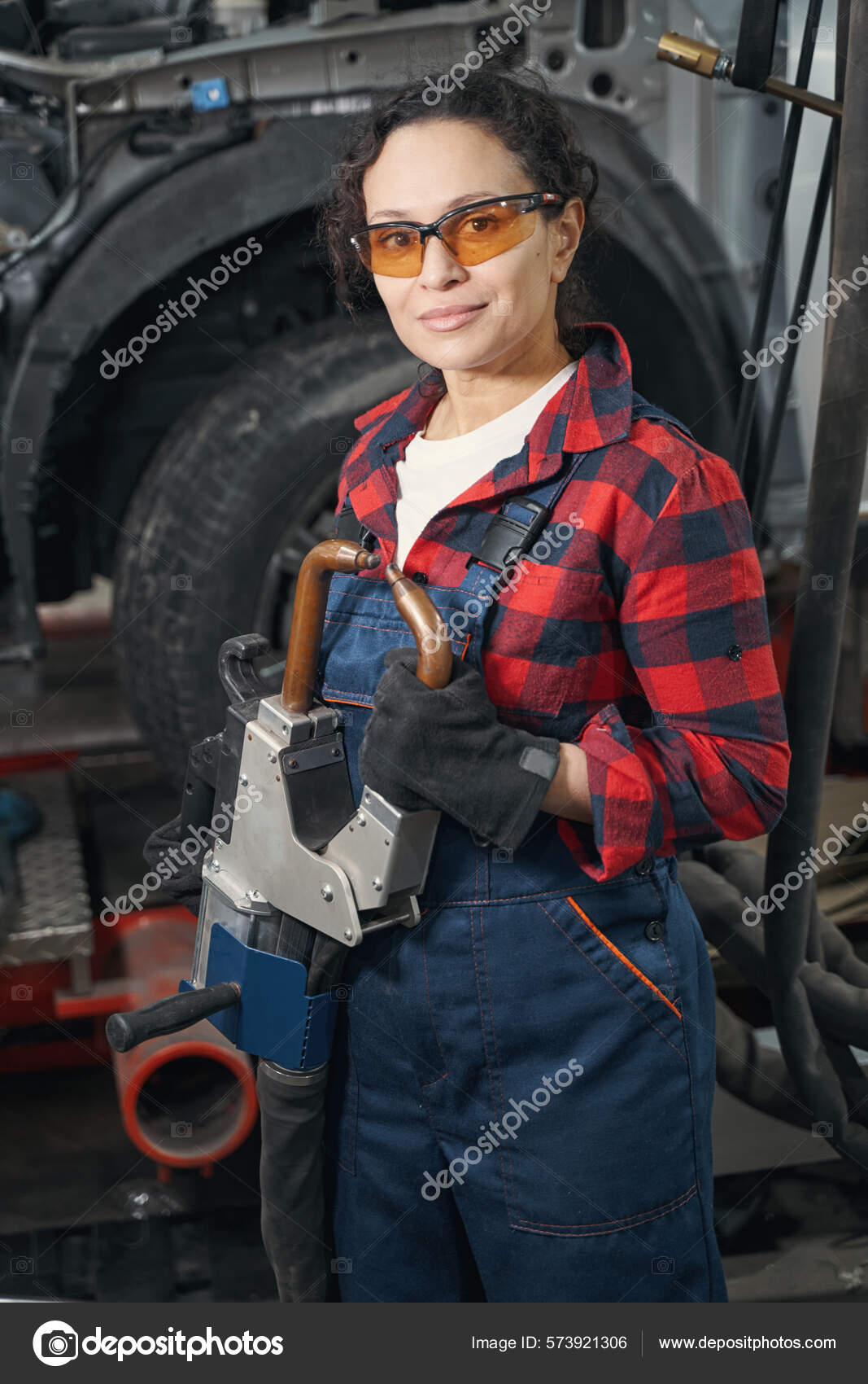 Female Vehicle Technician Safety Glasses Using Professional Automotive Equipment Automobile Stock Photo yacobchuk1 573921306