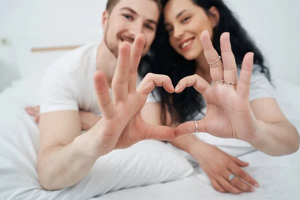 Smiling Happy Female Male Lying Bed Forming Heart Shape Hands — Stock Photo, Image