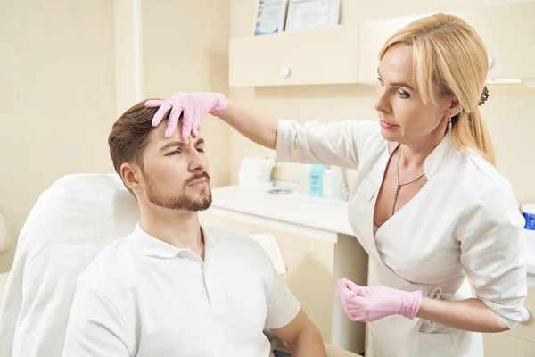 Frau Mit Konturenstift Presst Haut Auf Männliche Stirn Falte Vor — Stockfoto