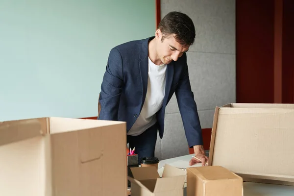 Man Leaning Notepad While Checking List Goods Surrounded Opened Boxes — Stock Photo, Image