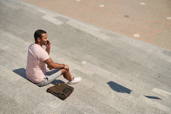 Young Male Person Seated Concrete Steps Communicating His Cell Phone — Photo