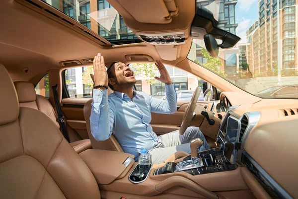 Happy Young Motorist Seated Car Cabin Arms Raised Sky — 스톡 사진