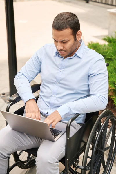 Serious Focused Disabled Male Person Seated Wheelchair Typing His Laptop — Stockfoto