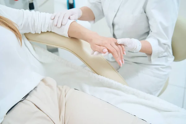 Doctor Medical Cosmetology Center Examines Patient Wrist — Foto de Stock