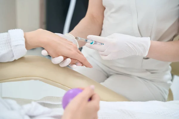 Hand skin rejuvenation with injections in a medical and cosmetology center