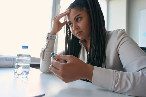 Exhausted Enterprise Employee Sitting Desk Drug Capsule Her Hand Touching — стоковое фото