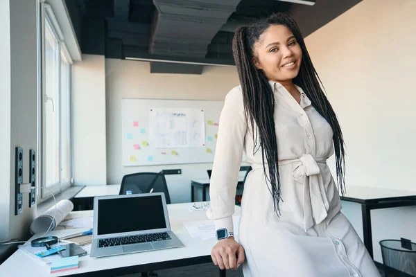 Smiling Pleased Female Entrepreneur Seated Edge Office Desk Looking Her — Φωτογραφία Αρχείου