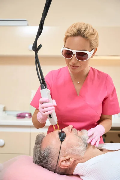 Woman Beautician Doing Laser Hair Removal Man Face Doctor Pink — ストック写真