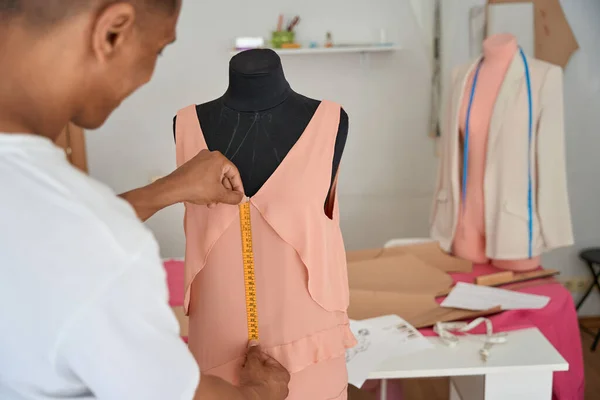 Youg Male Fashion Designer Using Tape Measurer Making Pink Dress — стоковое фото