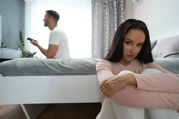 Quarrel Guy Young Woman Friend Sits Alone Floor Boyfriend Watches — Stockfoto