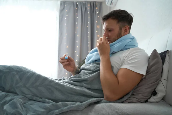 Guy Lies Bed Pillows Blanket Runny Nose Fever Has Thermometer — 图库照片