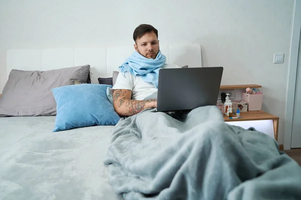 Guy Flu Laptop Works Home Lies Cozy Bed Pillows Wrapped — Zdjęcie stockowe
