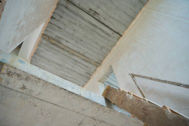 Photo of a wooden staircase to the second floor in an unfinished house