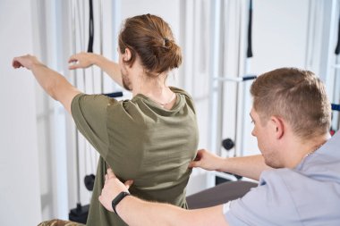 Military man undergoes a rehabilitation course in a sanatorium, the doctor takes care of him in the physiotherapy room
