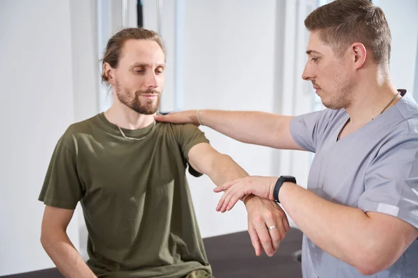 Military Doctor Military Sanatorium Helps Injured Soldier Develop Wounded Arm — Photo