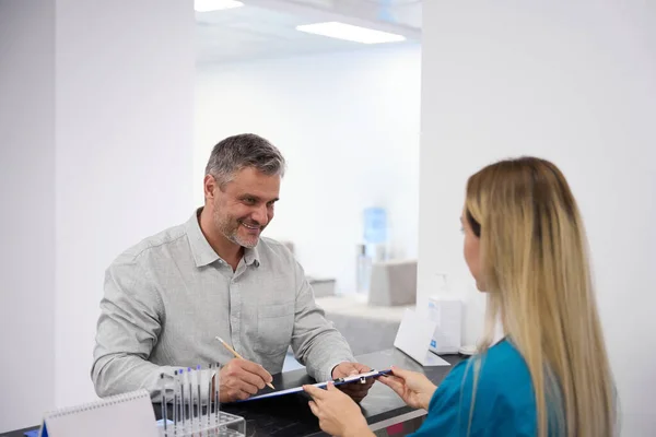 Woman White Long Hair Gives Documents Adult Man — Stock Photo, Image
