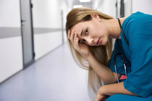 Doctor Holds His Head While Sitting Chair Lobby Hospital Looks — 图库照片