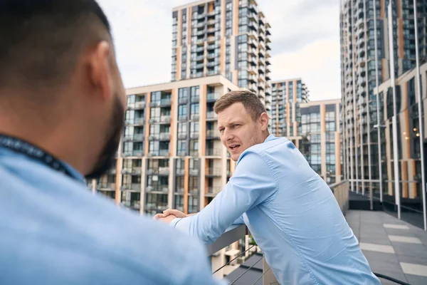 Serious Corporate Employee Leaning Balcony Guardrail Talking His Coworker — Stock Photo, Image