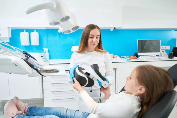 Pedodontist Giving Headset Preteen Child Lying Dental Chair Her Office — Stock Photo, Image
