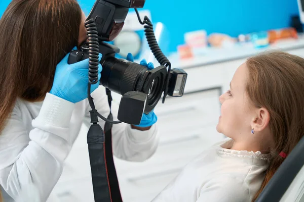 Çocuk Dişçisi Dijital Kamerayı Dişçi Koltuğunda Oturan Bir Kızın Önünde — Stok fotoğraf