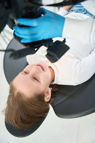 Pediatric Dentist Hands Aiming Digital Camera Joyous Preteen Girl Lying — Stock Photo, Image