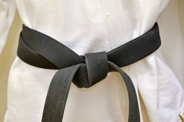 Karate Black Belt on White Uniform clipart