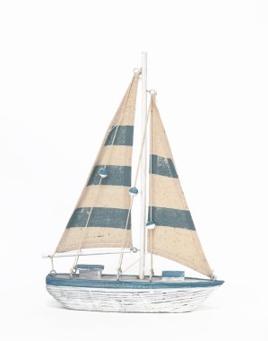 Wooden toy sailing boat on white background clipart