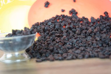 Kurutulmuş siyah kuru üzüm. Kuru üzümler kuruyan taze üzümlerle elde edilir. Kurutulmuş meyve grubuna dahil edilerek, eşlik edilmeden pişirilen veya yenilen en popüler gıdalardan biri haline getirilirler..