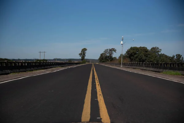 Highway in the interior of Brazil. Asphalt road with little movement. Rural landscape on highway in Brazil. Feeling of freedom. Reflection and self-knowledge.