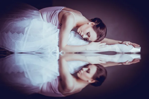 Lying ballerina with the reflection — Stock Photo, Image