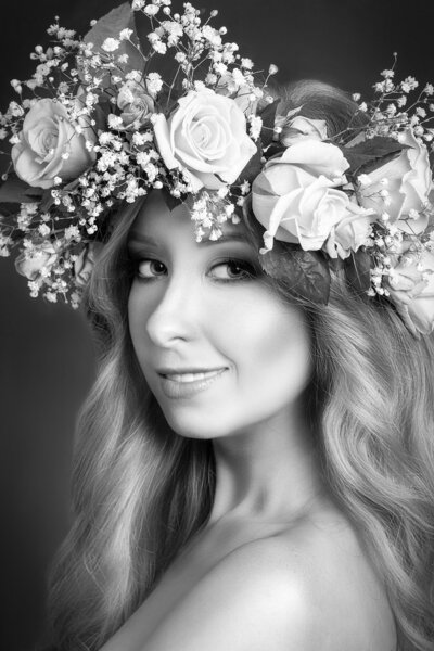 Beautiful young girl wearing floral wreath, black and white photo