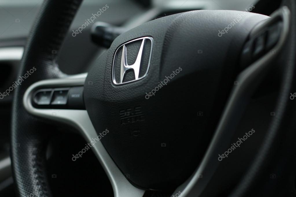 The wheel automobile, car, Honda logo on the steering wheel, black wheel, detail of the car, in the car, at the wheel, macro wheel