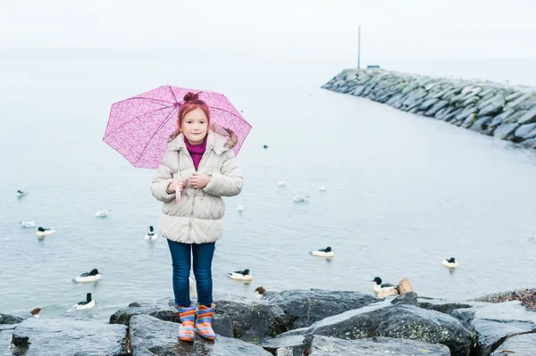 Cute little girl with pink umbrella — Stock Photo, Image