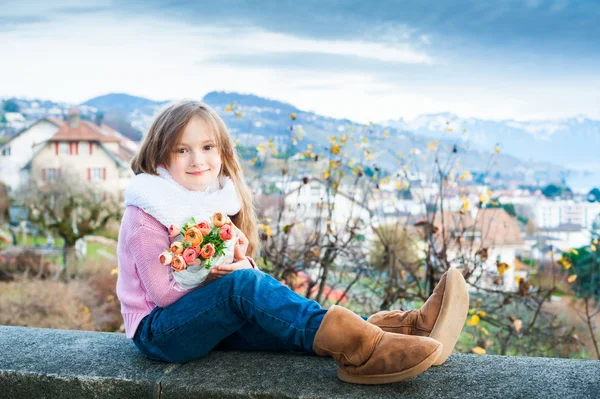 Güzel, küçük bir kız portresi ile buket bahar çiçek — Stok fotoğraf