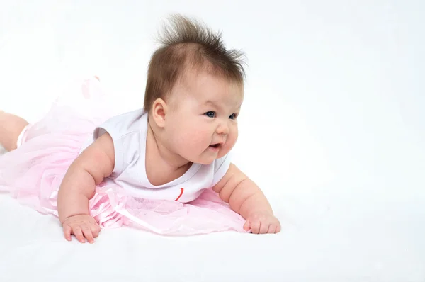 Newborn baby in pink dress s looking away — Stock Photo, Image