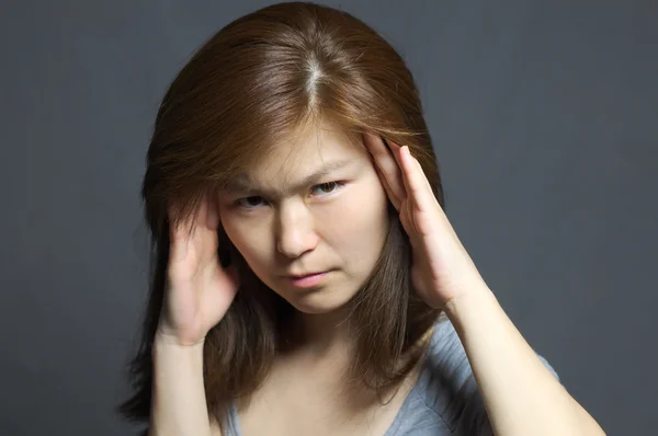 Asian woman with headache looking — Stock Photo, Image