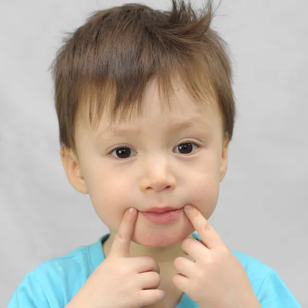 Boy forces a smile — Stock Photo, Image