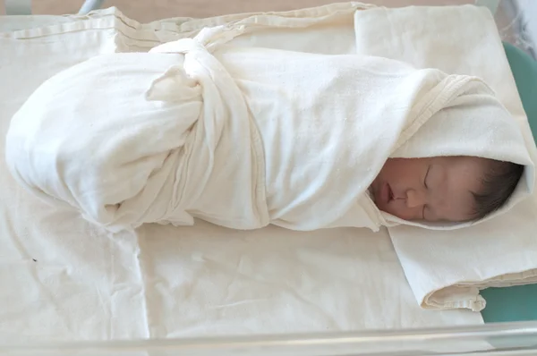 Newborn baby, wrapped in swaddling clothes — Stock Photo, Image
