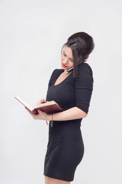 Pretty business lady standing with book — Stock Photo, Image