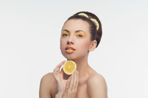 Young woman with oranges and makeup — Stock Photo, Image