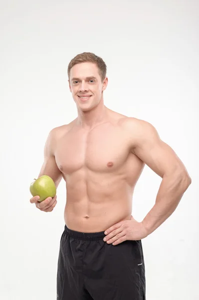 Athlete with an apple — Stock Photo, Image