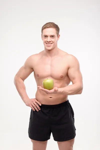 Athlete with an apple — Stock Photo, Image