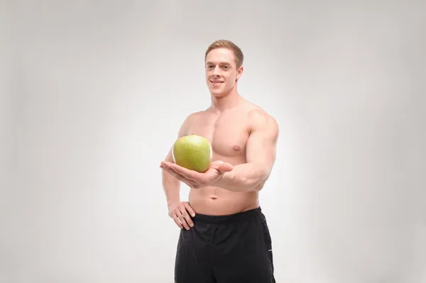 Athlete with an apple — Stock Photo, Image