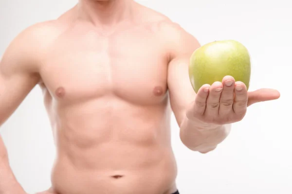 Athlete with an apple — Stock Photo, Image