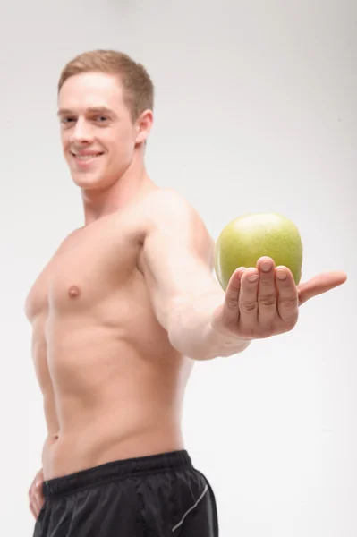Athlete with an apple — Stock Photo, Image