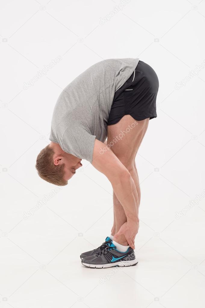 Man athlete doing warming exercises